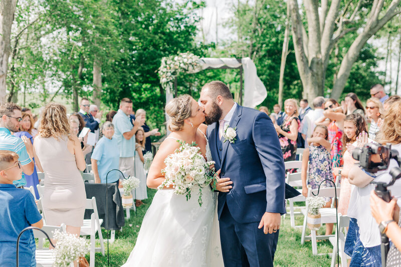 Engaged couple poses in flower field near Indianapolis Canal