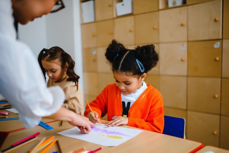 student receiving help from her teacher