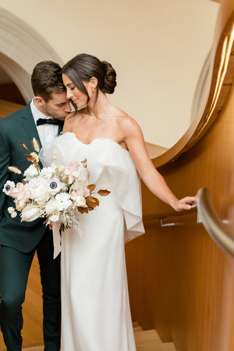Bride and groom share their first kiss as husband and wife on their wedding day on the beach of Zurich Ontario