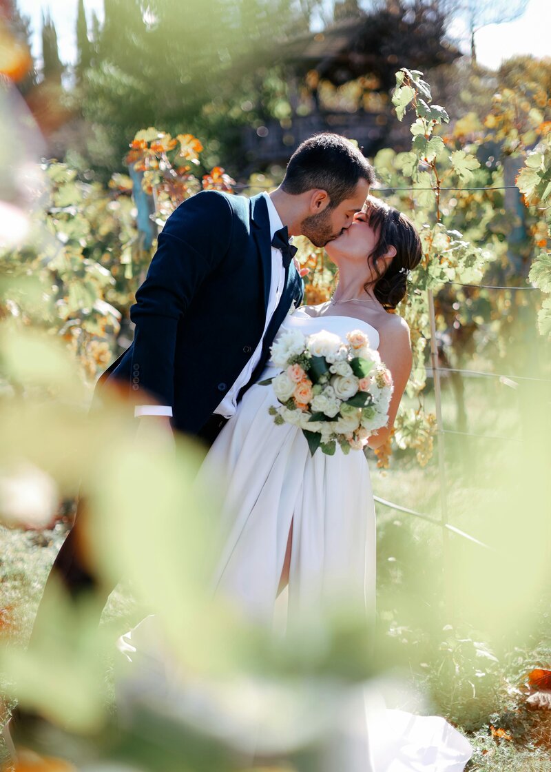 A bride and groom dancing outdoors on their wedding day.