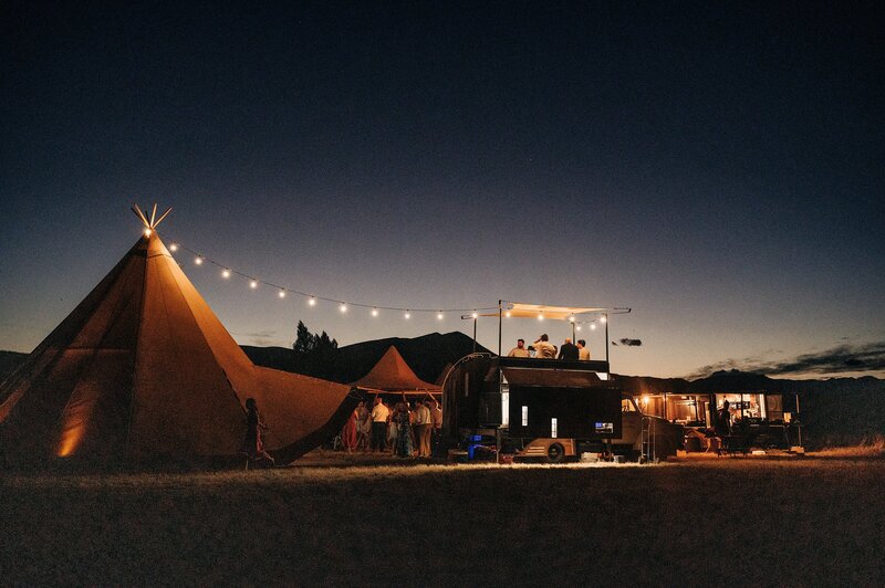 festival style wedding setup with tipis and festoon lights in a christchurch vineyard