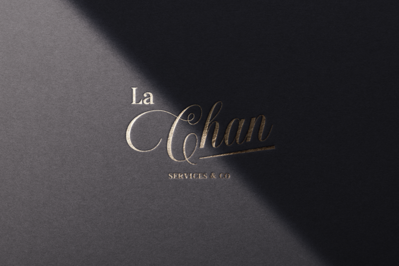 La Chan Logo Design, embossed typography on black paper background