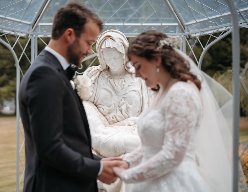 a Catholic couple praying together on their wedding day