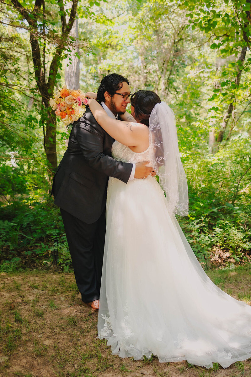 bride and groom share a kiss at their wedding in oklahoma city