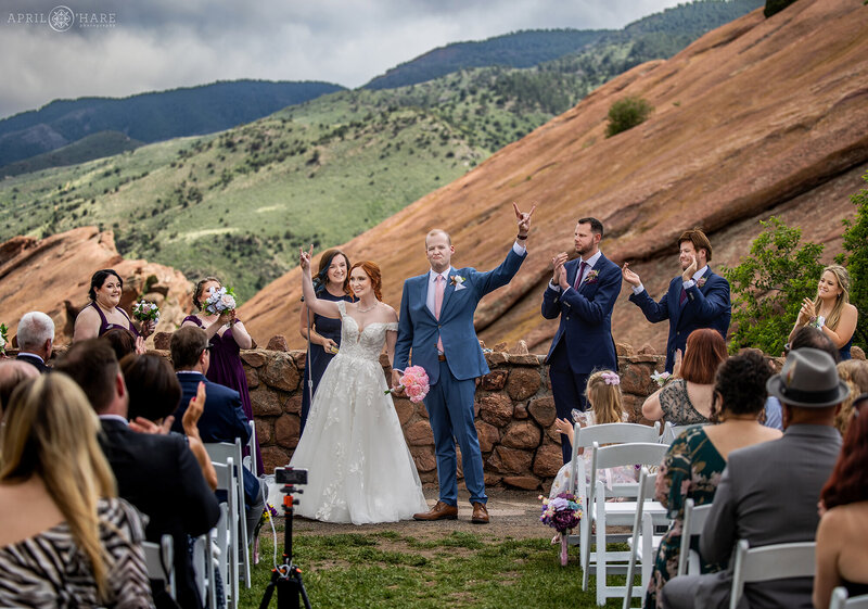 Couple Celebrate the end of their wedding ceremony at Red Rocks Trading Post Backyard