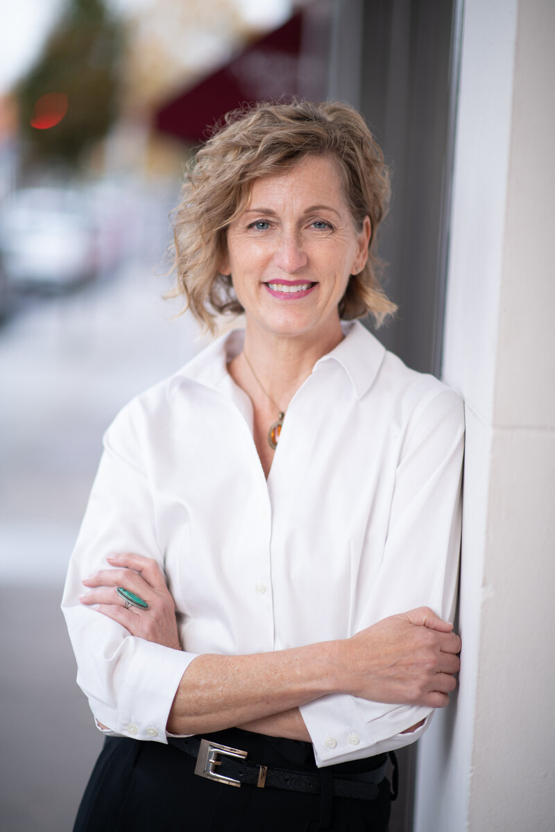 Woman leaning against building