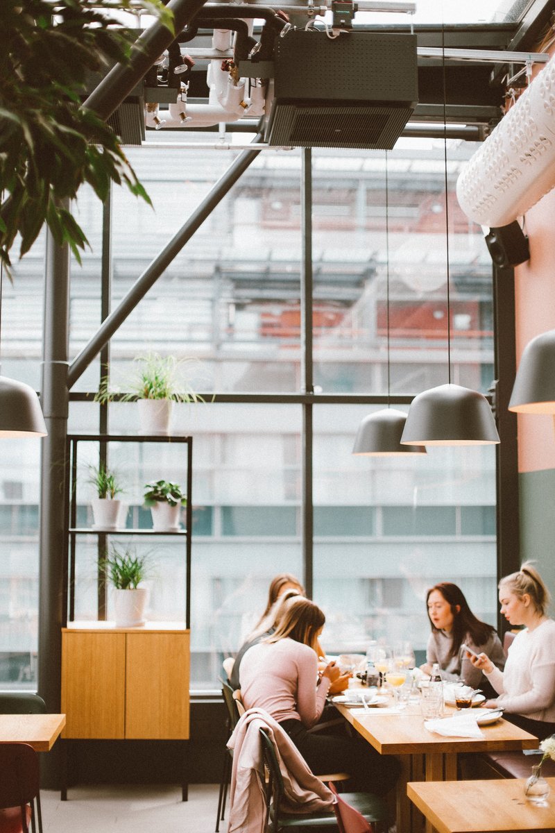 four-women-sitting-in-front-of-food-in-room-1517226