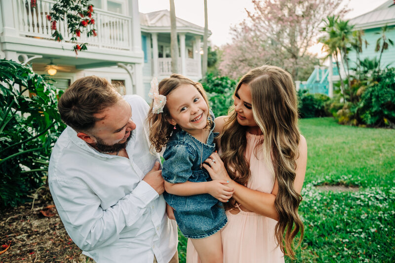 Family photoshoot with little girl, laughing and hugging