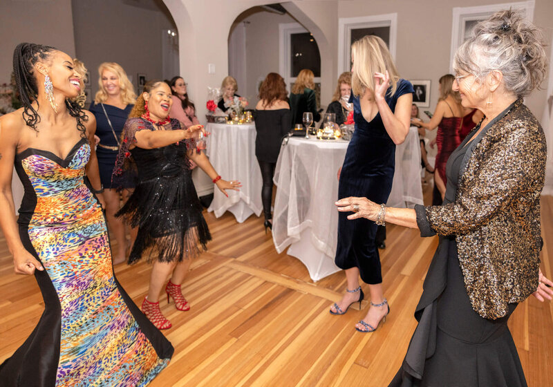 An event scene with guests socializing, beautifully decorated tables, and soft candlelight ambiance.