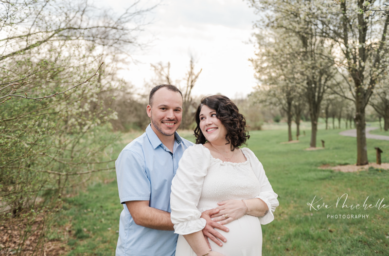 husband and wife posing during maternity session by photographers baltimore md
