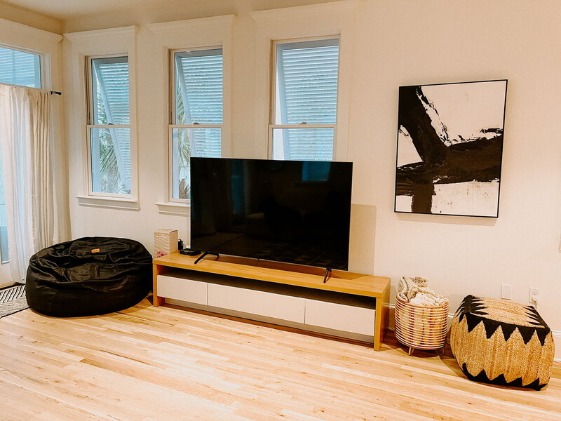living room with widescreen tv and black artwork
