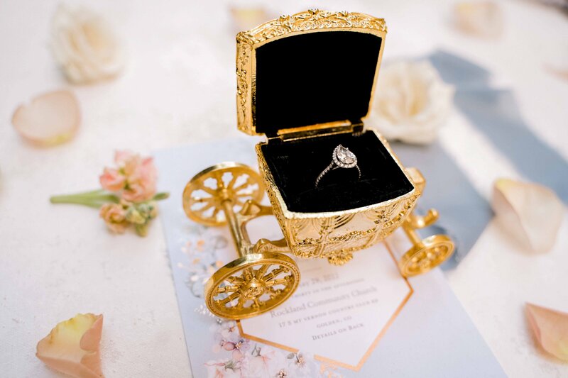 Wedding ring inside a golden cart ring box