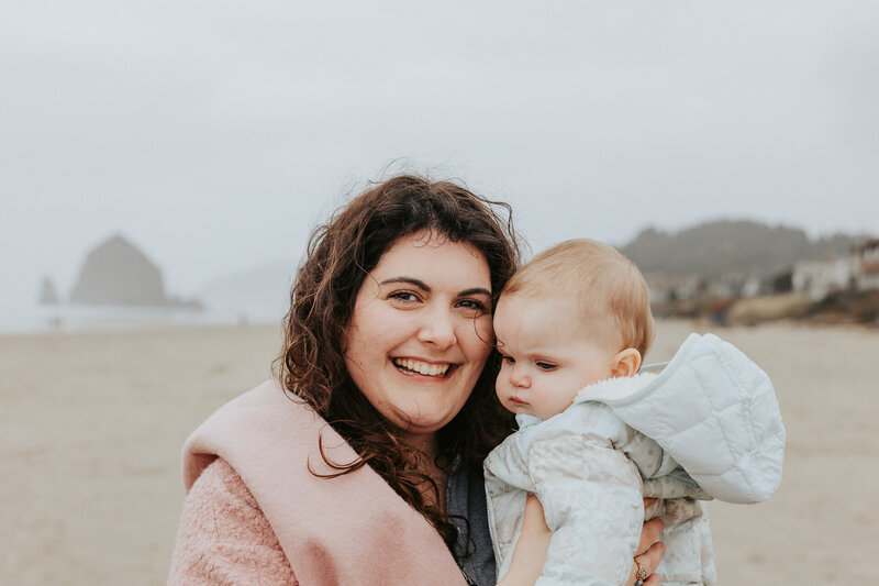 wedding photographer lindsey wickert in front of haystack rock at cannon beach oregon