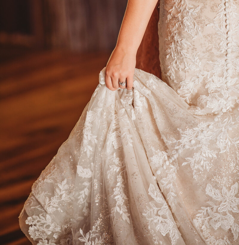 A bride holding her wedding gown in her bridal suite at the Barn on Unity Farm in Princeton, West Virgina