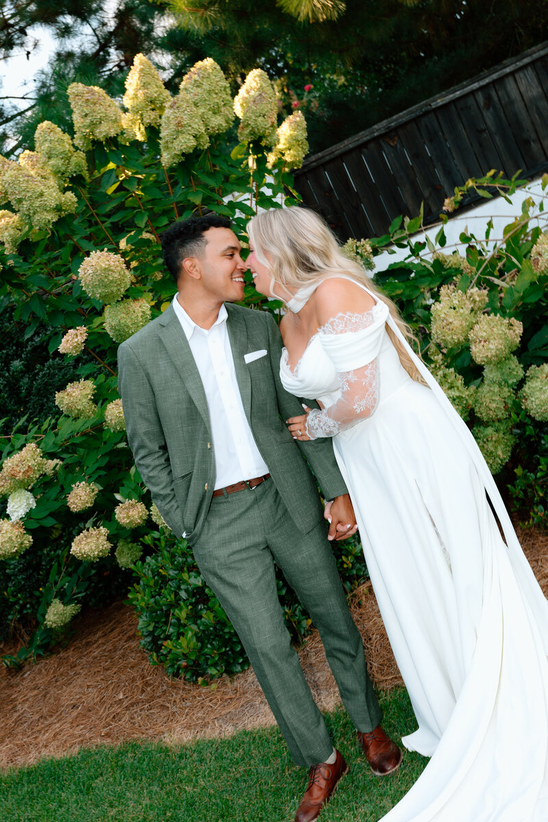 a documentary photo of a bride and groom walking in the sun at Amaterra Winery in Portland Oregon