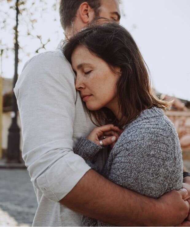A couple stand with their eyes closed as the man embraces his partner. She is leaning her head against his chest. Both appear happy and content. This could symbolize a relationship that is healing from infidelity. We offer affair counseling in Florida to support your relationship. Contact an affair recovery therapist for support with infidelity recovery today.