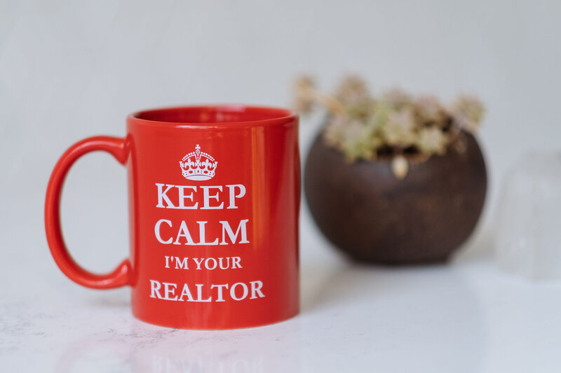 Stock photo of a coffee cup that says "KEEP CALM I'M YOUR REALTOR"