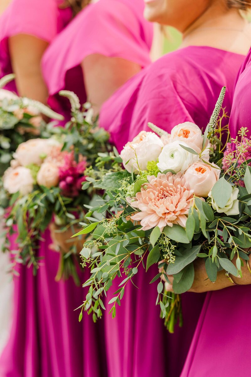 Magenta bridesmaid dresses with florals. Milwaukee Wedding Photographer.