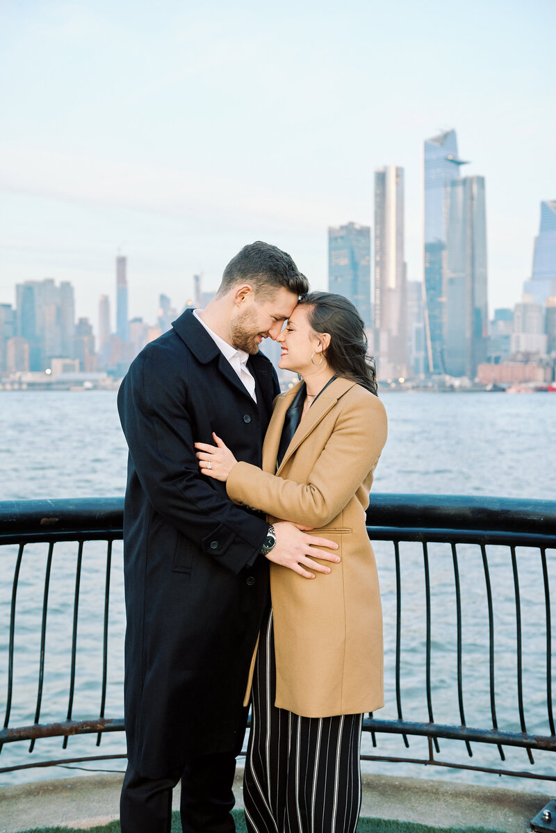 A Couple embrace after a Jersey City Proposal, New York City skyline in view.  Photo taken by Proposal Photographer Corey Lamar Photography
