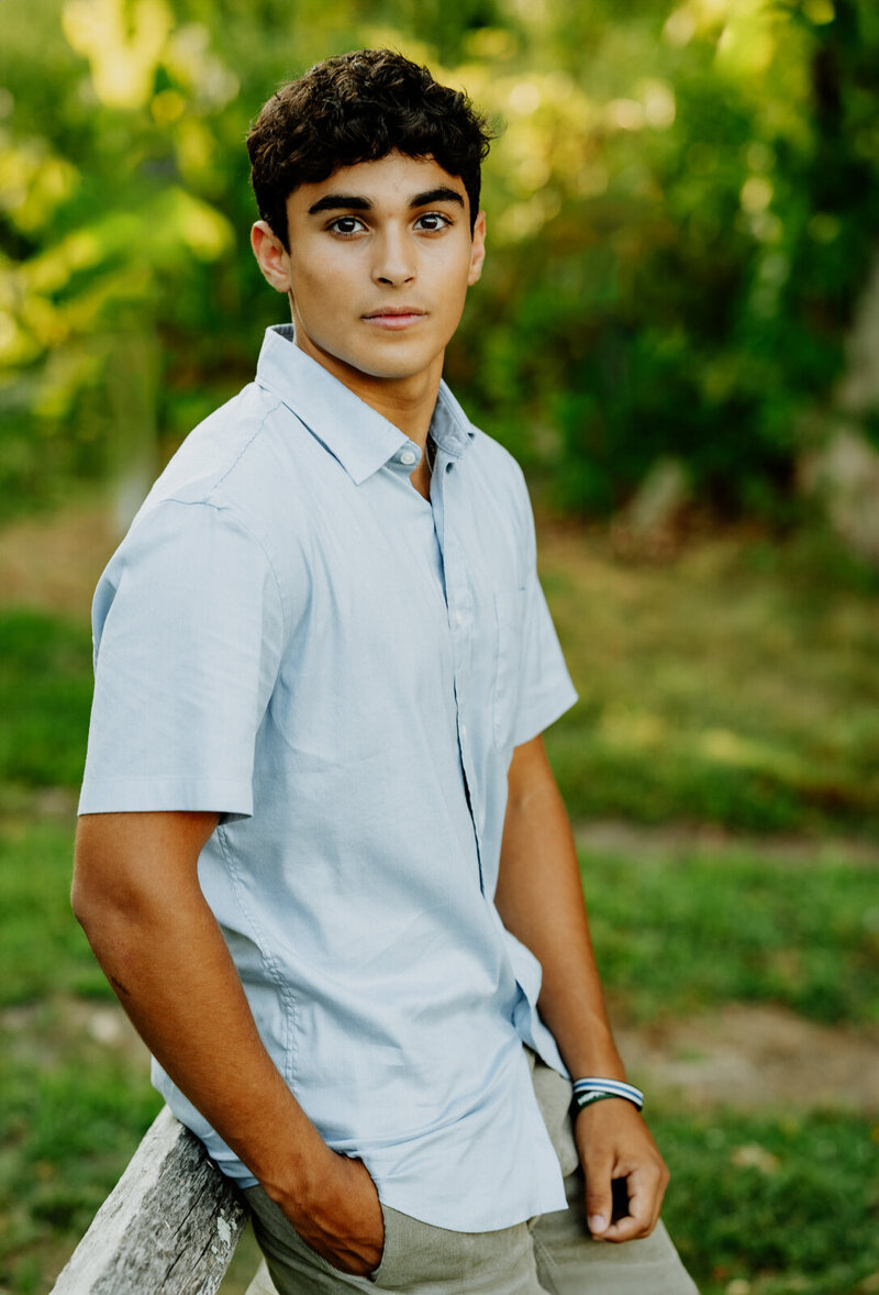 Hopkinton senior boy looking at the camera in a field. 