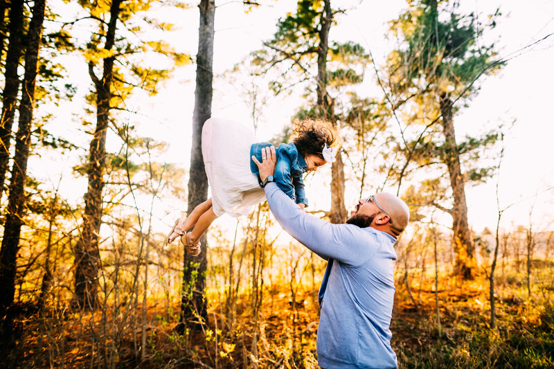 dad throwing daughter