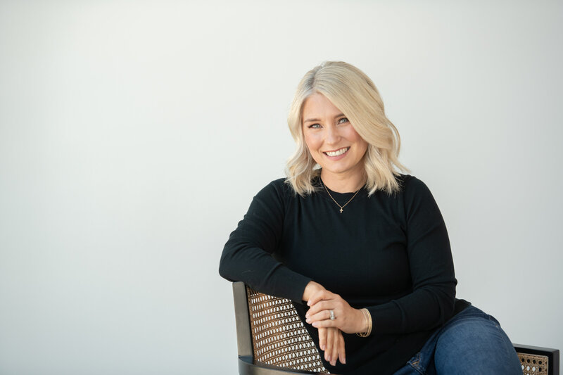Image of Christian Apologist Liz Cobo sitting at a white desk.