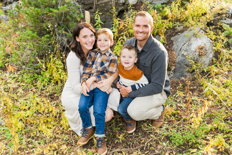 family crouching and smiling at the camera together