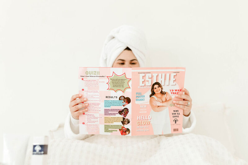 Macayla Hopper holding her custom skincare magazine featuring her esthetic services in Hartselle Alabama