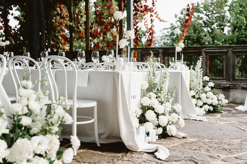 Woman  setting up table with flowers and candles