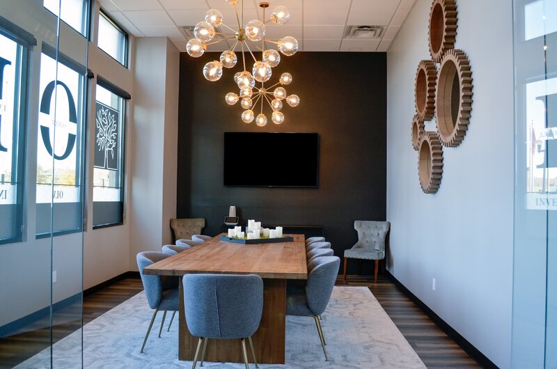 Modern conference room with light blue chairs and a dark wooden table
