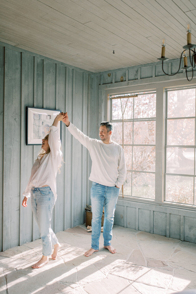 Couple kissing on forehead and holding hands in Elora ON