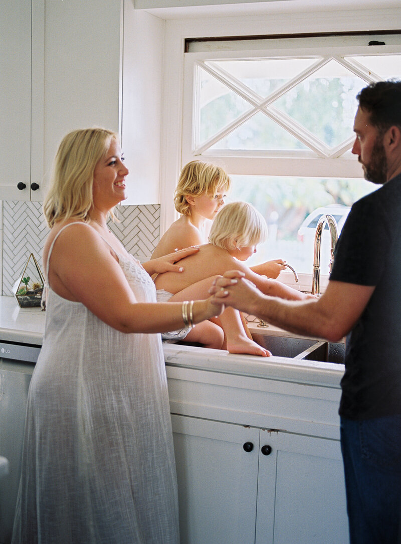 family hangs out in the kitchen sink