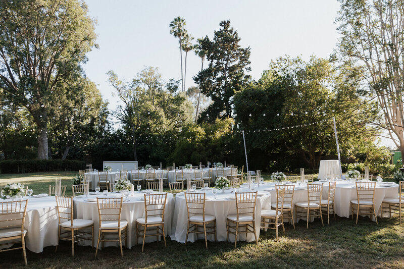 Pam and Brian’s elegant outdoor wedding reception with white chairs and mountain views, planned by Beyond the Event and photographed by Coyprint.