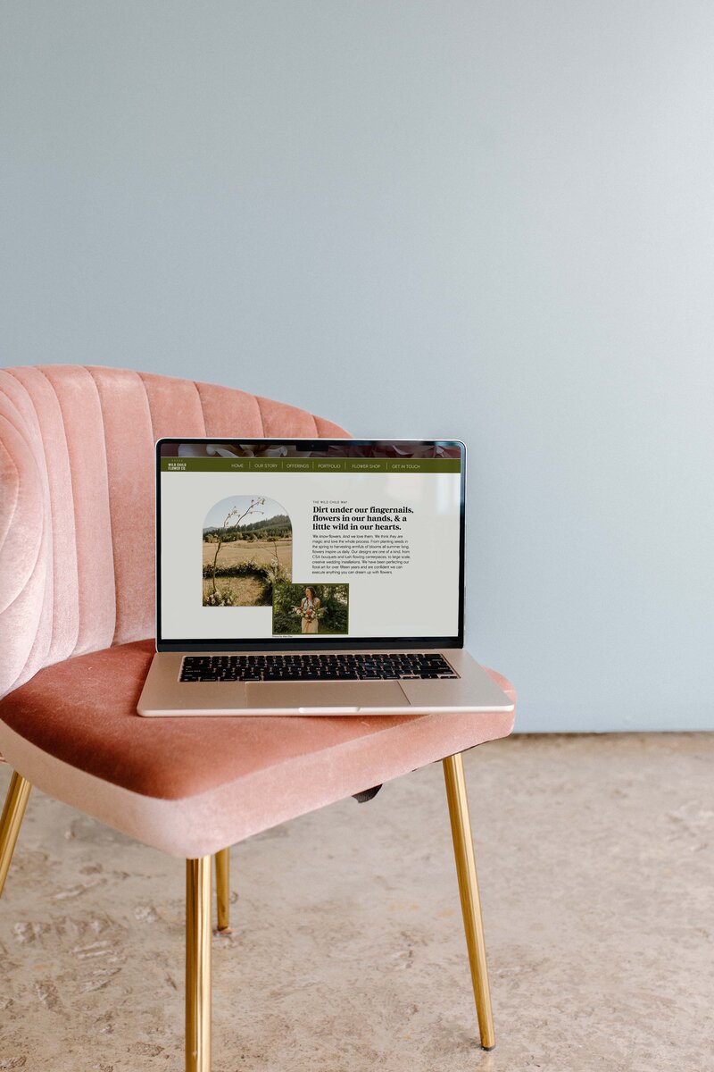 An open laptop sits on a pink chair and displays a florist's website, representing copywriting for creatives and web design services by Bloem Creations. 