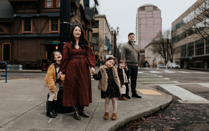 Family holding each other's hand in downtown Portland, Oregon