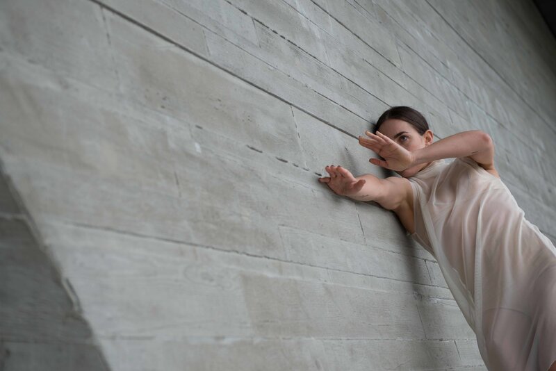 Contemporary Ballet dancer Kirsten Wicklund dancing on wall at UBC
