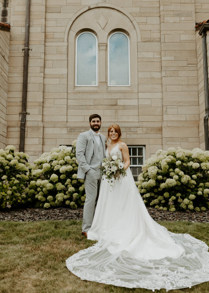 Bride and Groom pose outside of church they got married in Duluth, Minnesota wedding photography