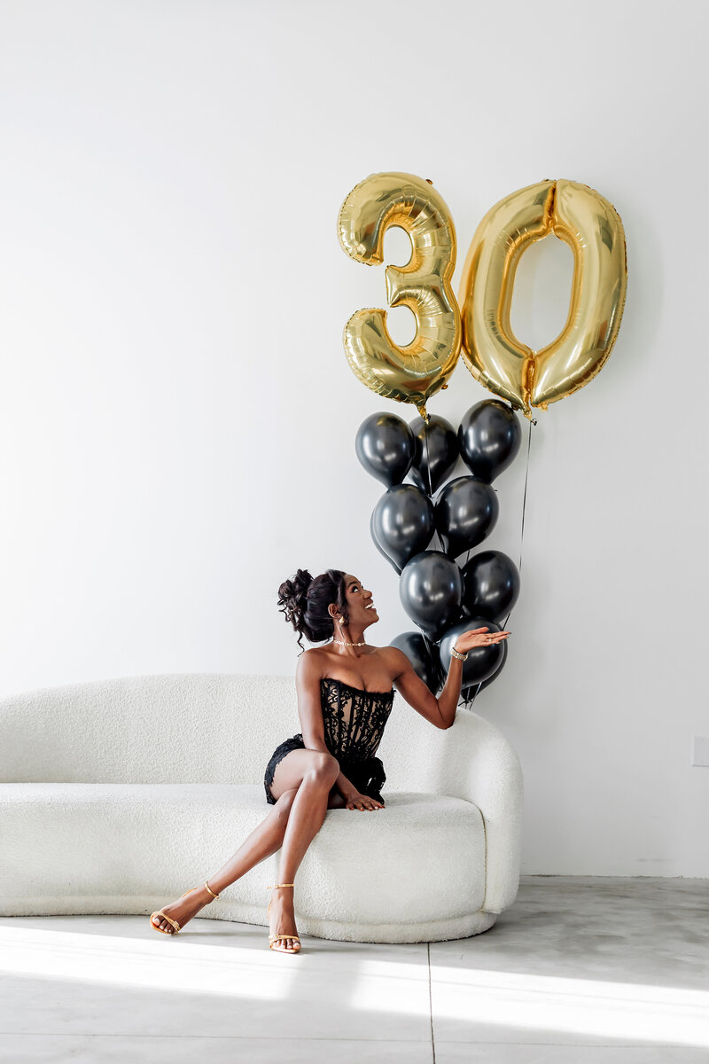 woman in studio with birthday balloons photo