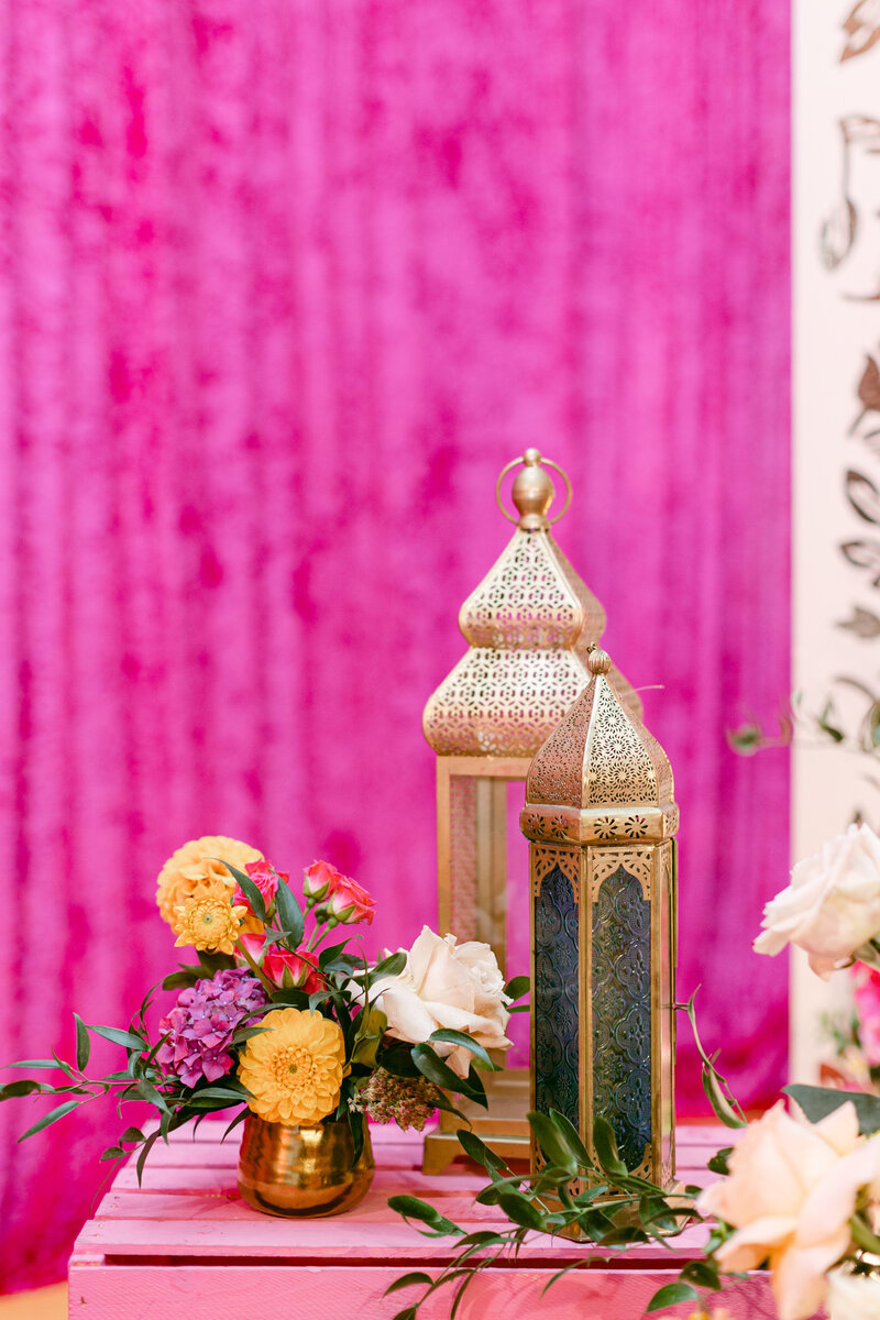 gold sikh decor sitting on a pink wooden table