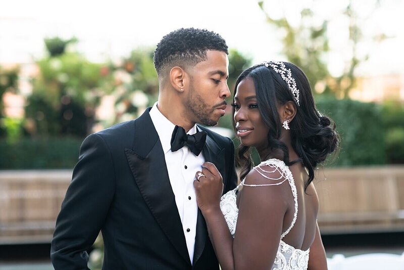 Black couple gazing in each others eyes after their  rooftop ceremony