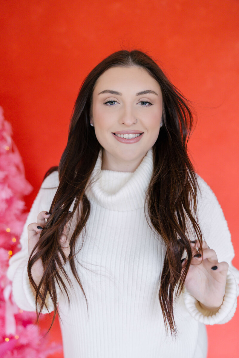 brunnete woman wearing cozy sweater smiling for camera