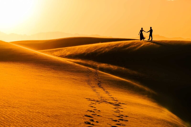 Couple running on a dune at White Sands New Mexico