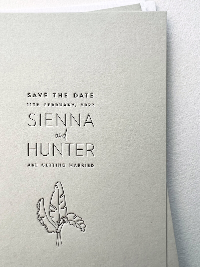 Luxury letterpress wedding invitation close up with leaf outline - Sienna