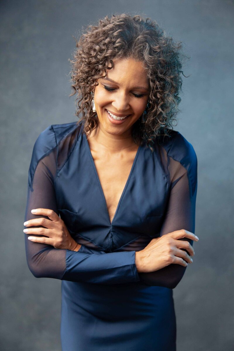 Woman in blue dress laughs by California portrait photographer