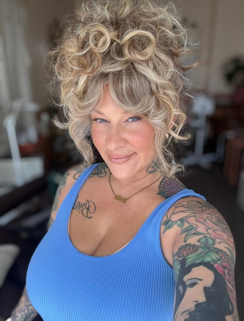 Libby an eugene makeup artist smiles at the camera.