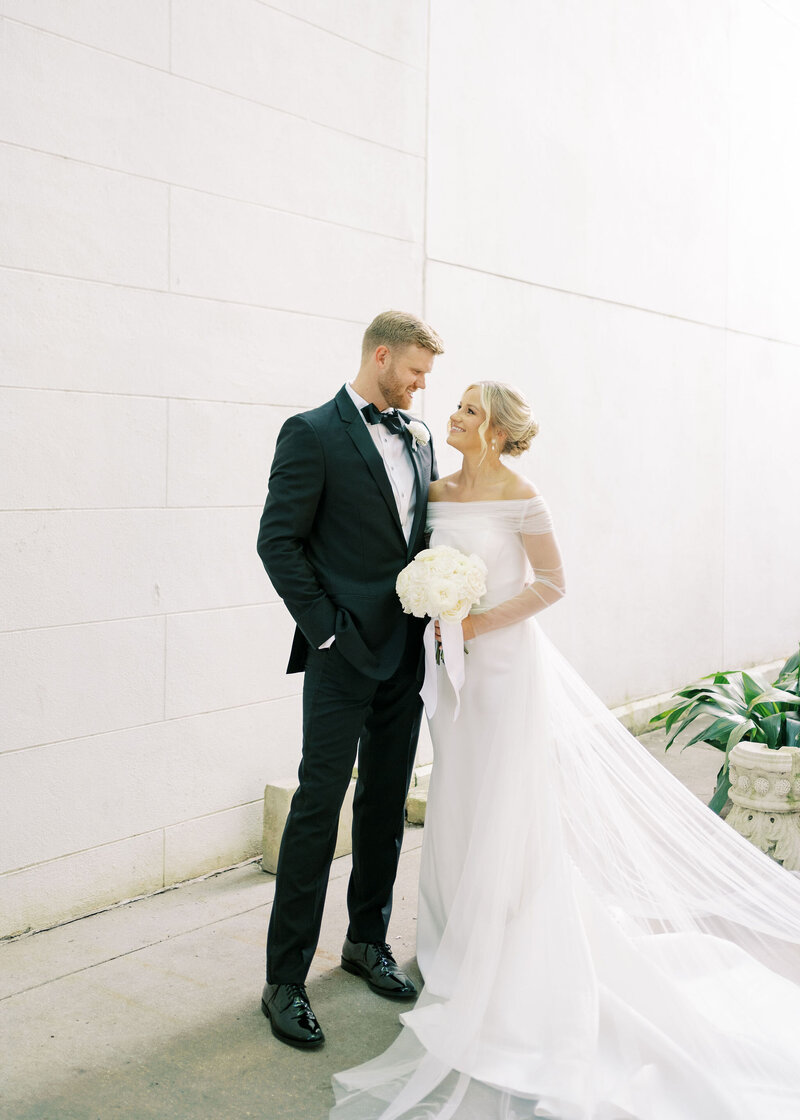 a bride and groom smiling at each other