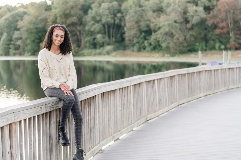 girl sitting on the bridge at a Lake Fairfax Park during Reston, VA senior session