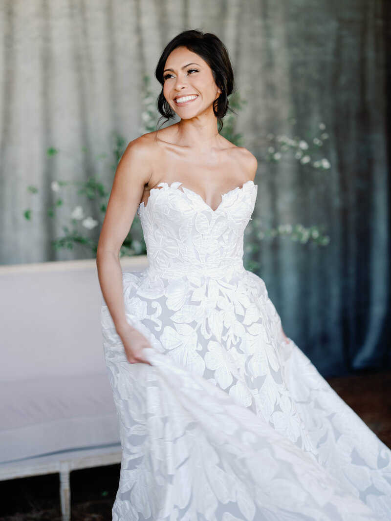 Bride is joyfully looking toward the side in her oscar de la renta dress
