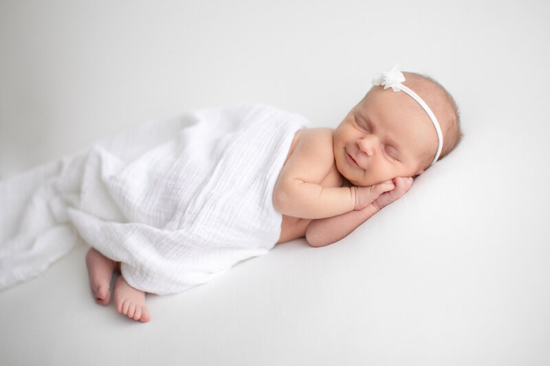 Newborn baby smiling during portrait sesson with Boise Photography Studio Tiffany Hix
