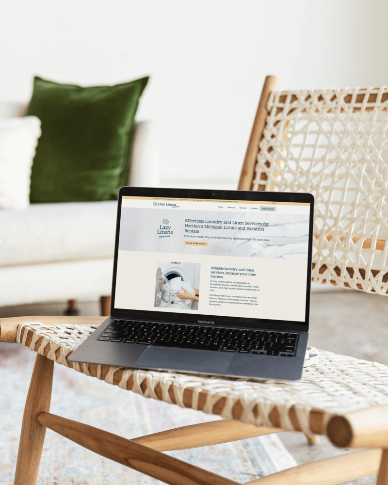 Minimalist website design for creative entrepreneurs shown on laptop in a modern, light-filled branding studio.
